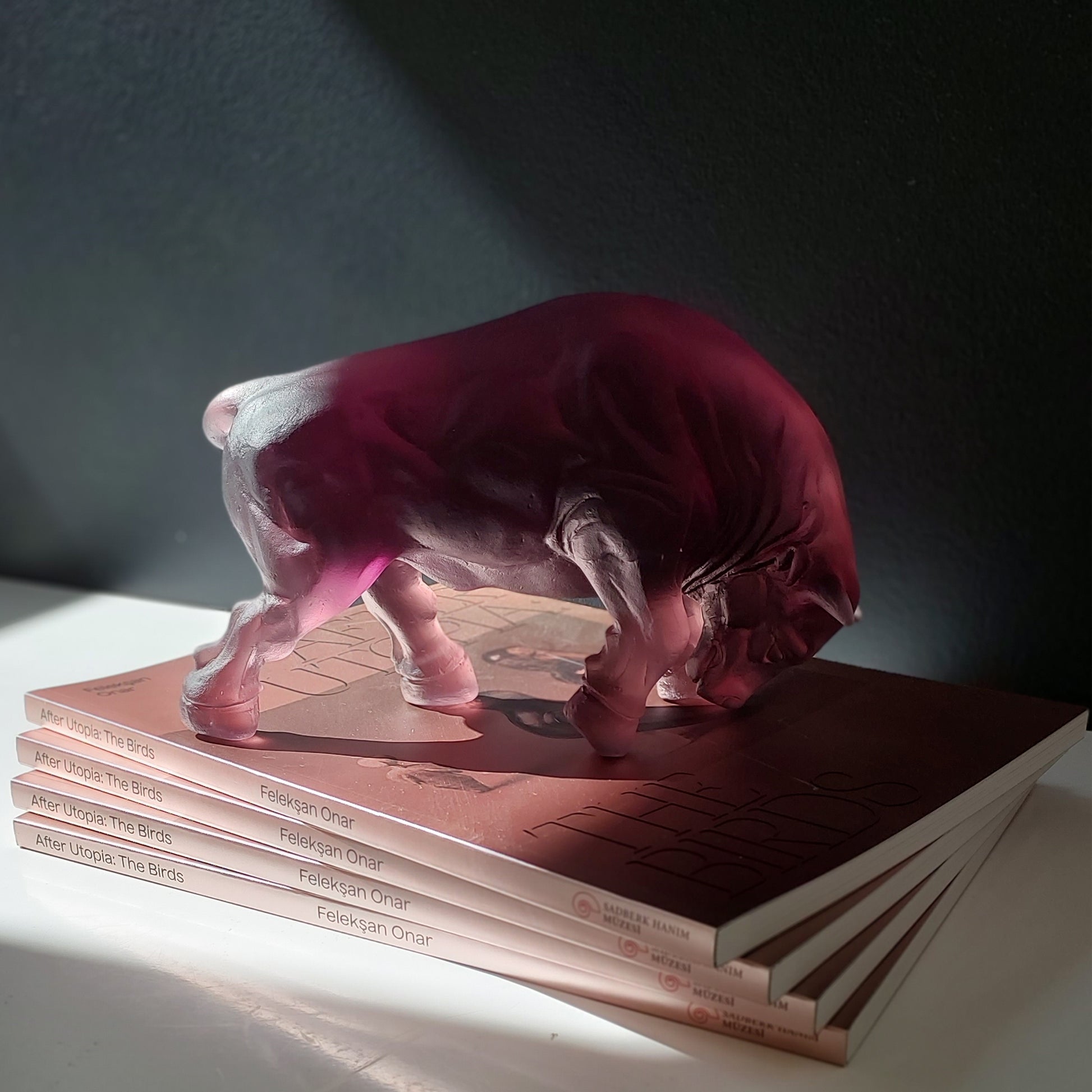 Bull Cast Glass Sculpture Amethyst on stack of books