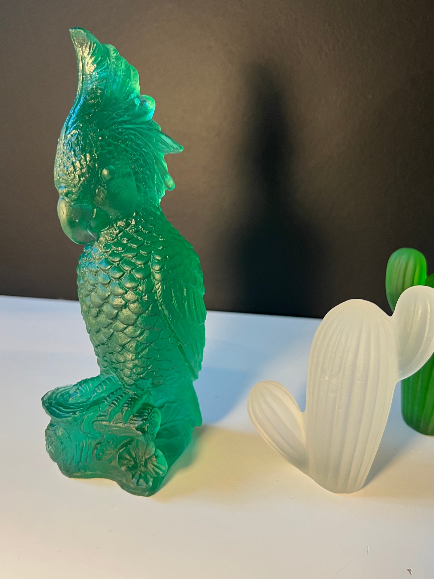 Rio Parrot Cast Glass Sculpture Emerald green next to ice glass cactus