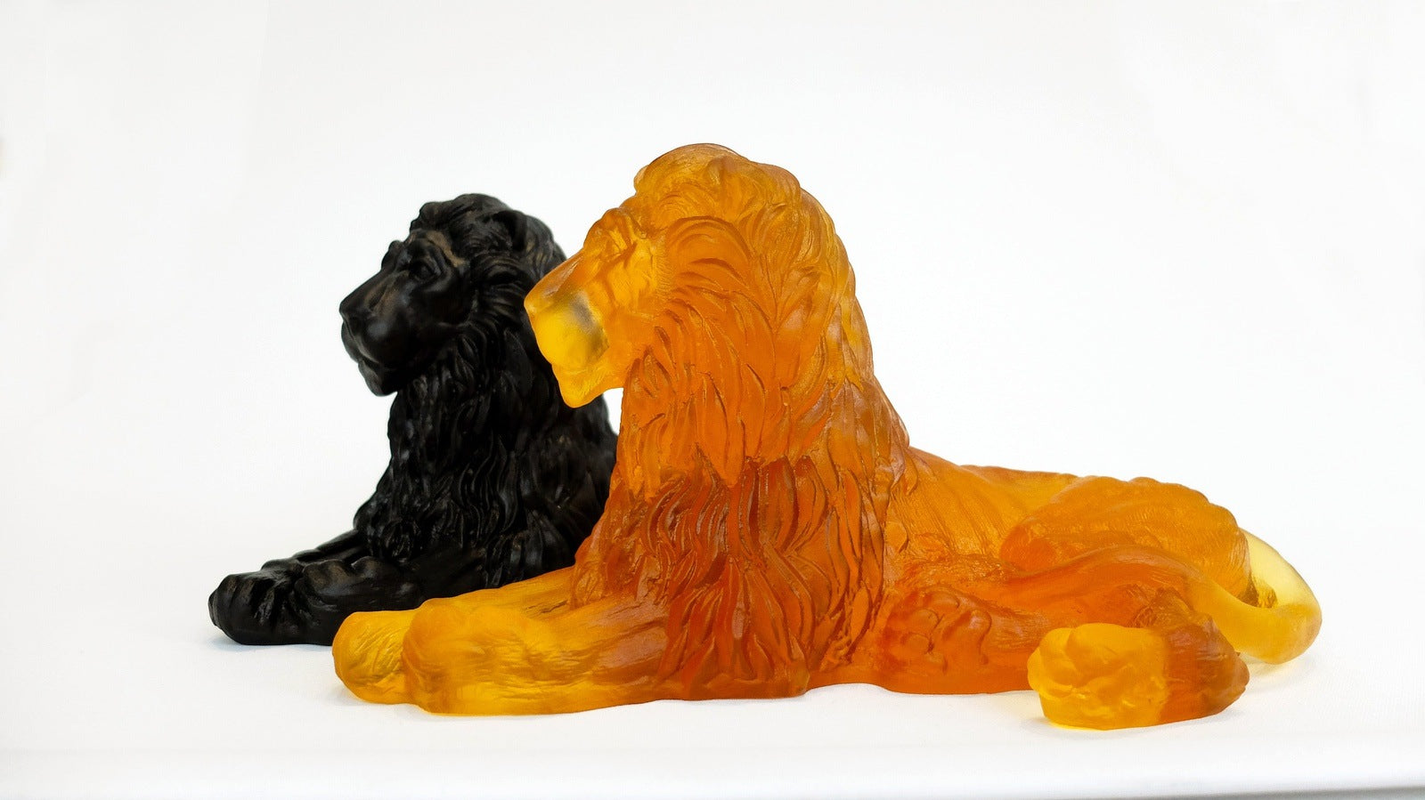 Lion 2 Premium Glass Sculptures Amber in front and Black in back looking in same direction