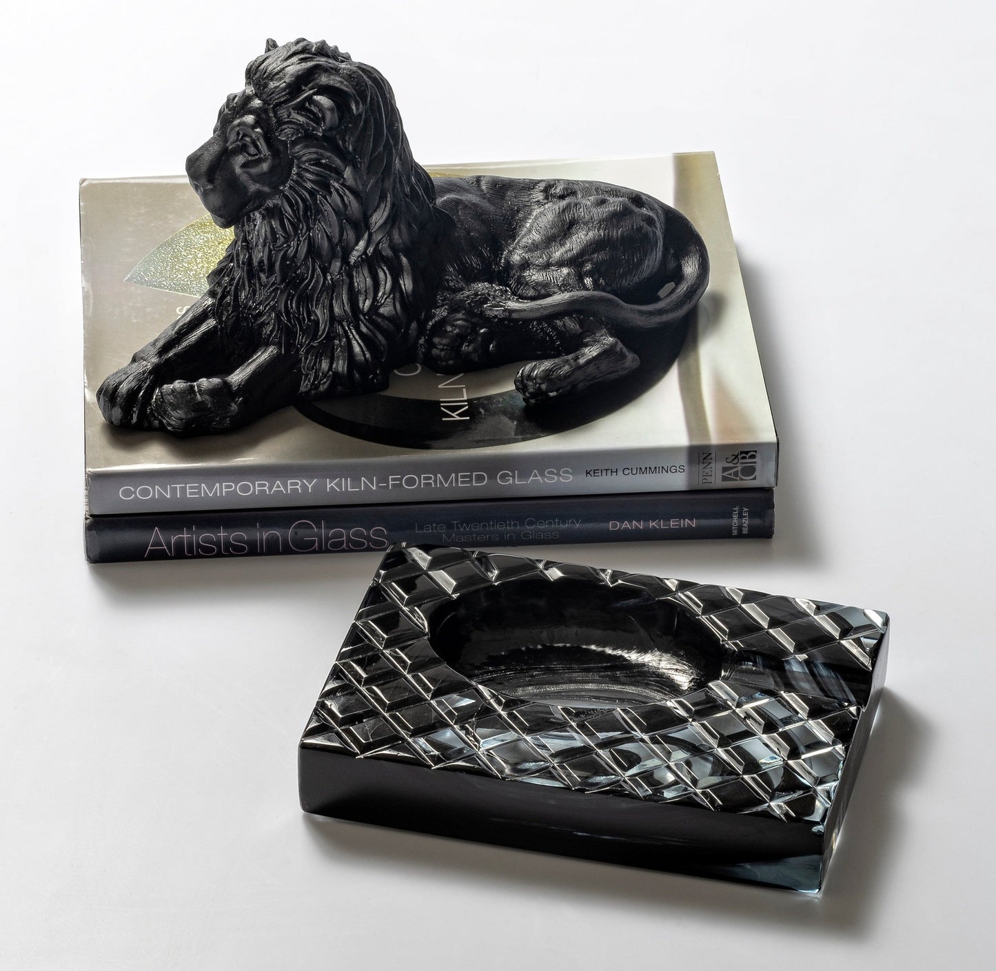 Lion Premium Glass Sculpture Black on a stack of books