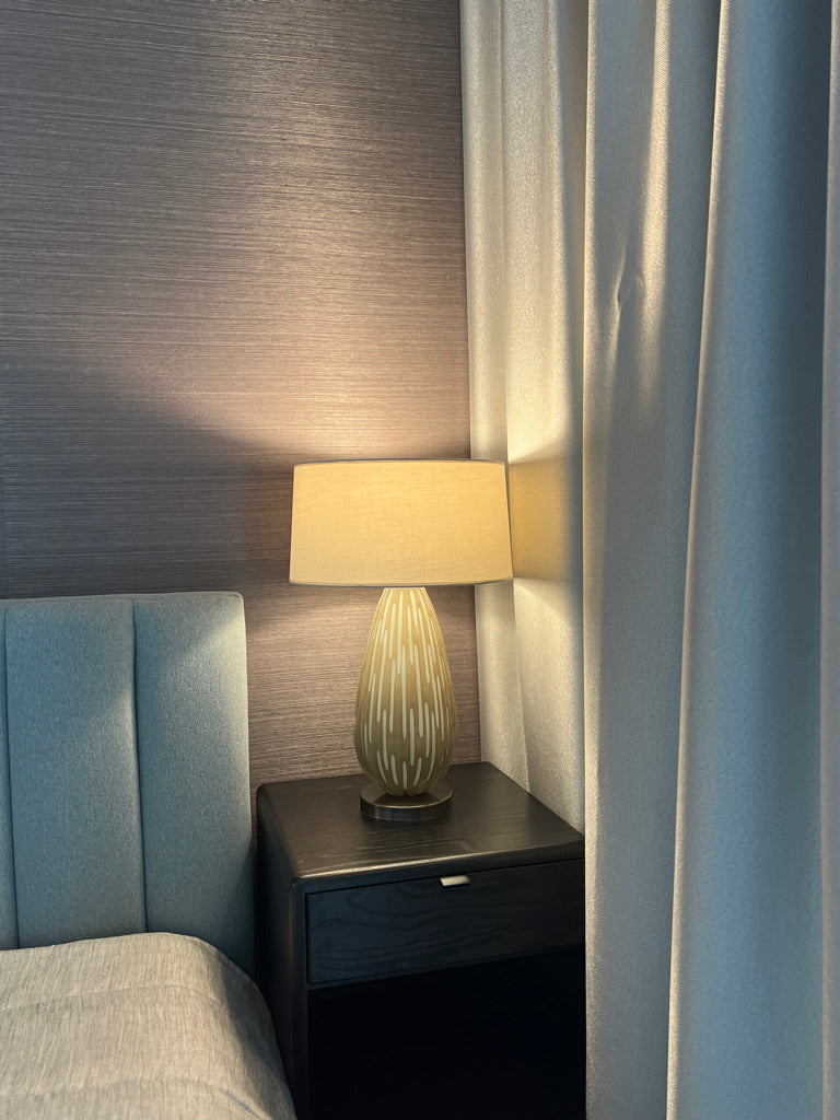 Tear Drop Table Lamp turned on near bed