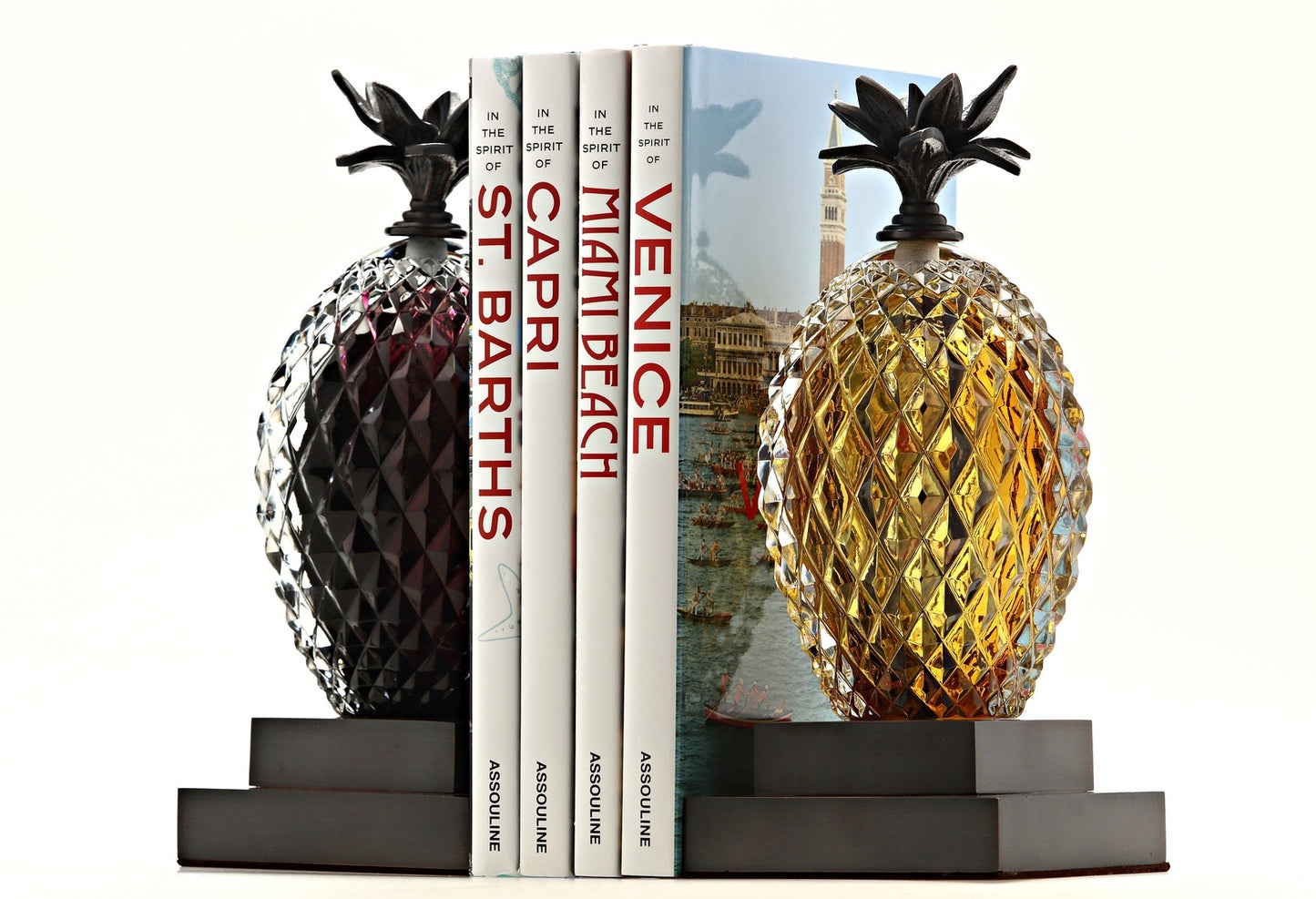Pineapple Bookend Amethyst and Amber between a stack of books
