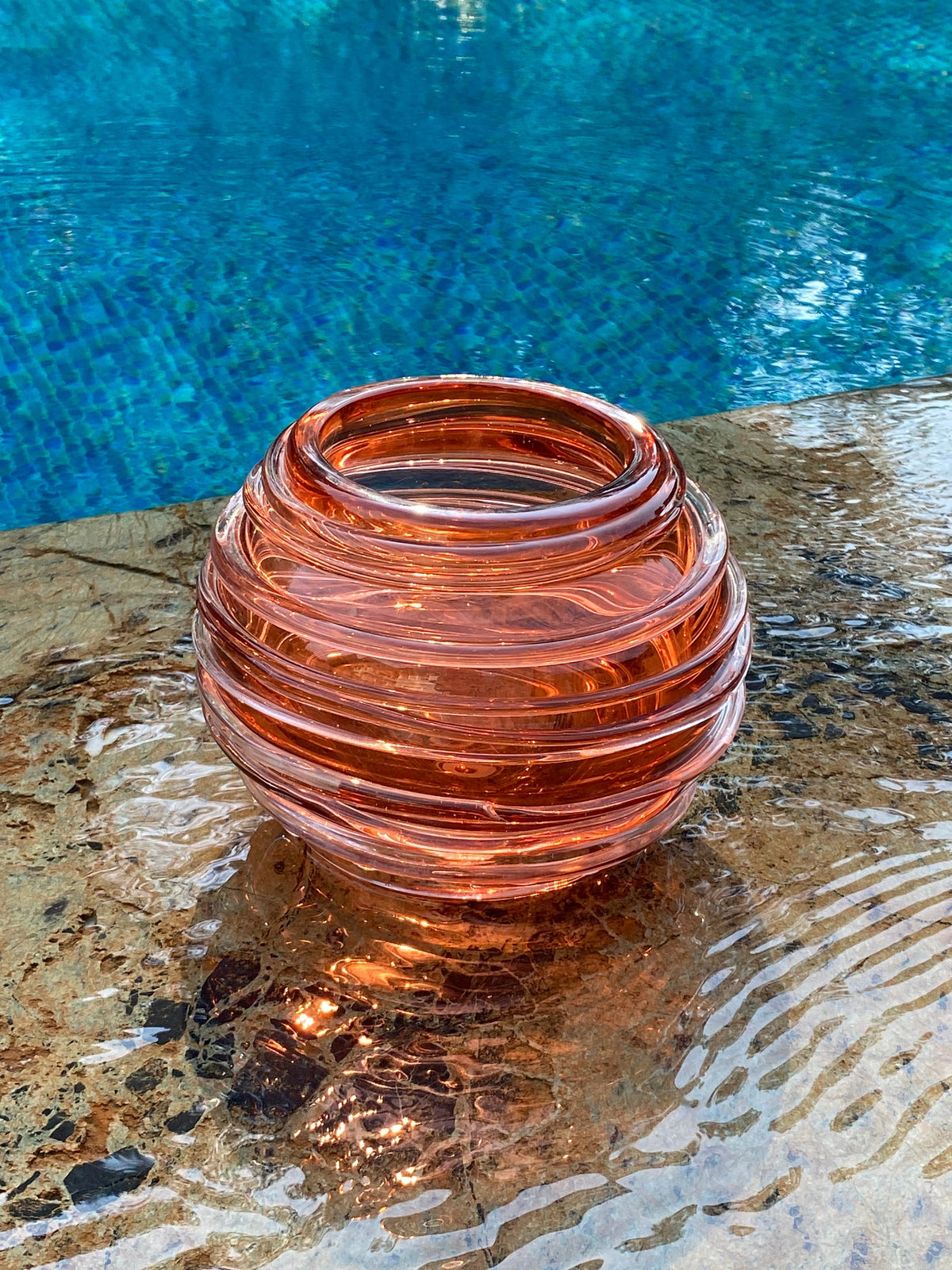 Ripples Glass Vase Sunset besides a pool